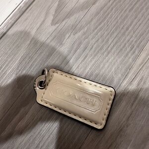 Coach white leather hangtag bag charm.